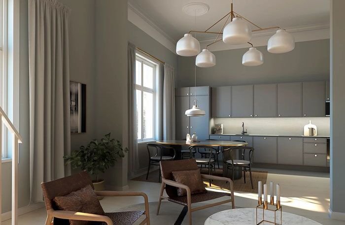 Sirkkalan Kreivittären asunto Turussa: korkea huone, jossa on harmaa keittiö, pyöreä ruokapöytä, nojatuolit ja designvalaisimet.